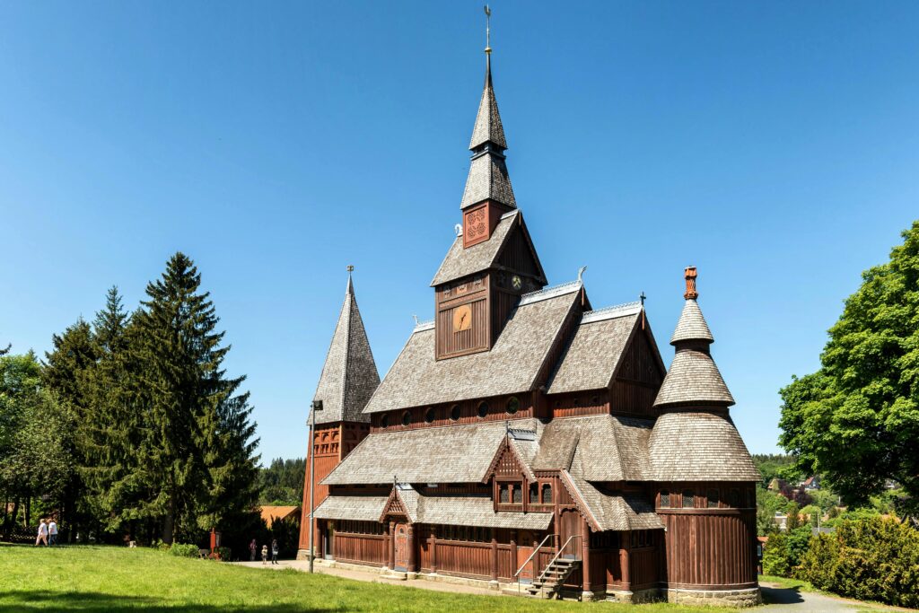 Explore the stunning architecture of the Gustav Adolf Stave Church in Goslar, set against a clear blue sky.
