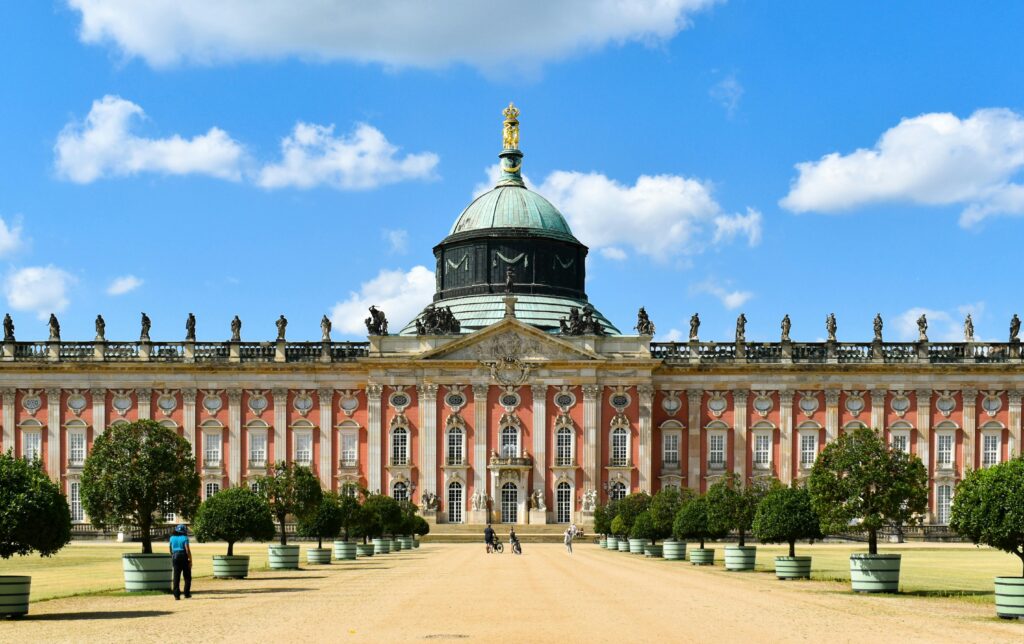 Beautiful facade of the New Palace in Sanssouci Park, Germany, under a clear blue sky.